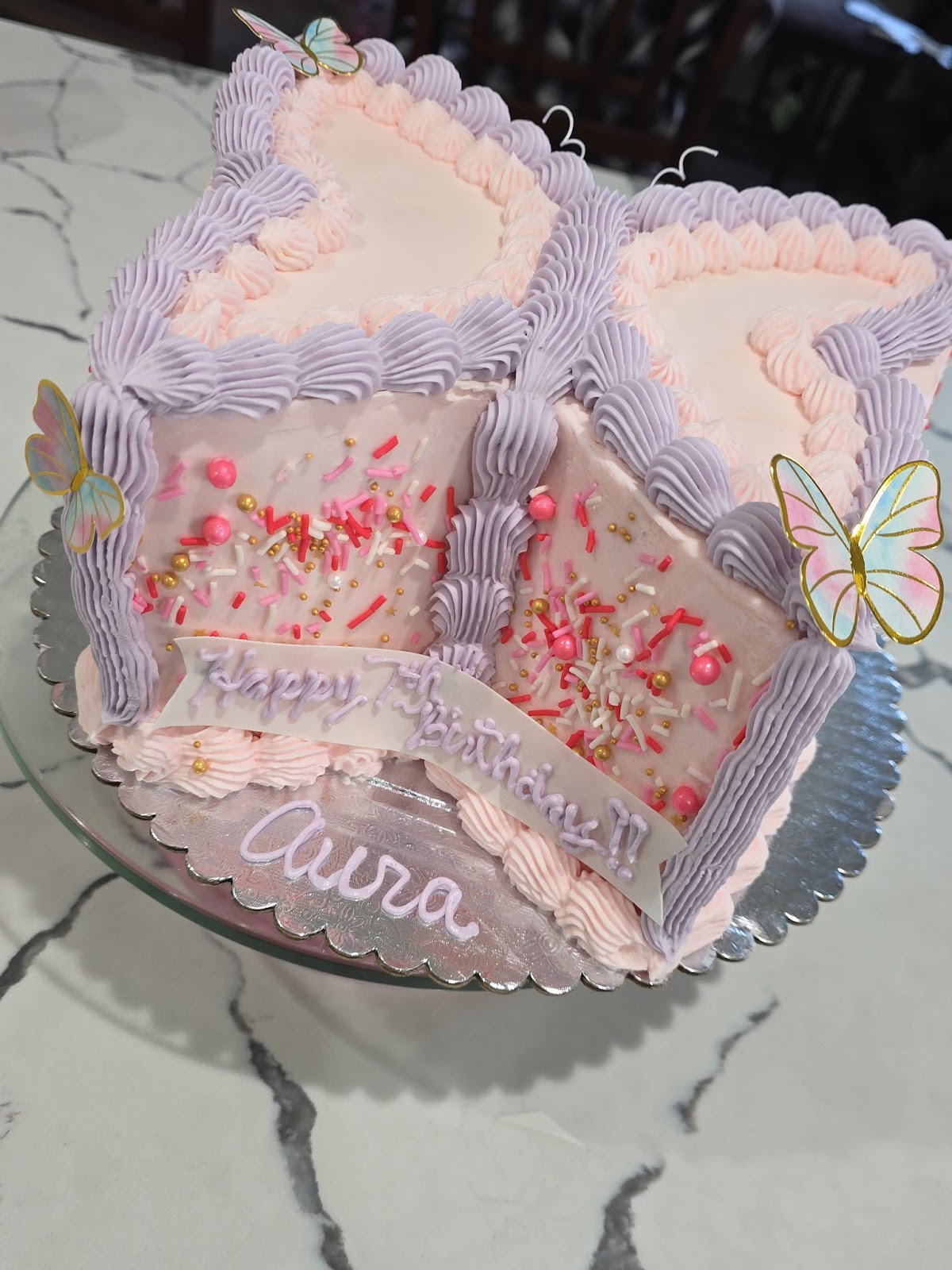 Pink and lilac butterfly birthday cake with piped shell borders